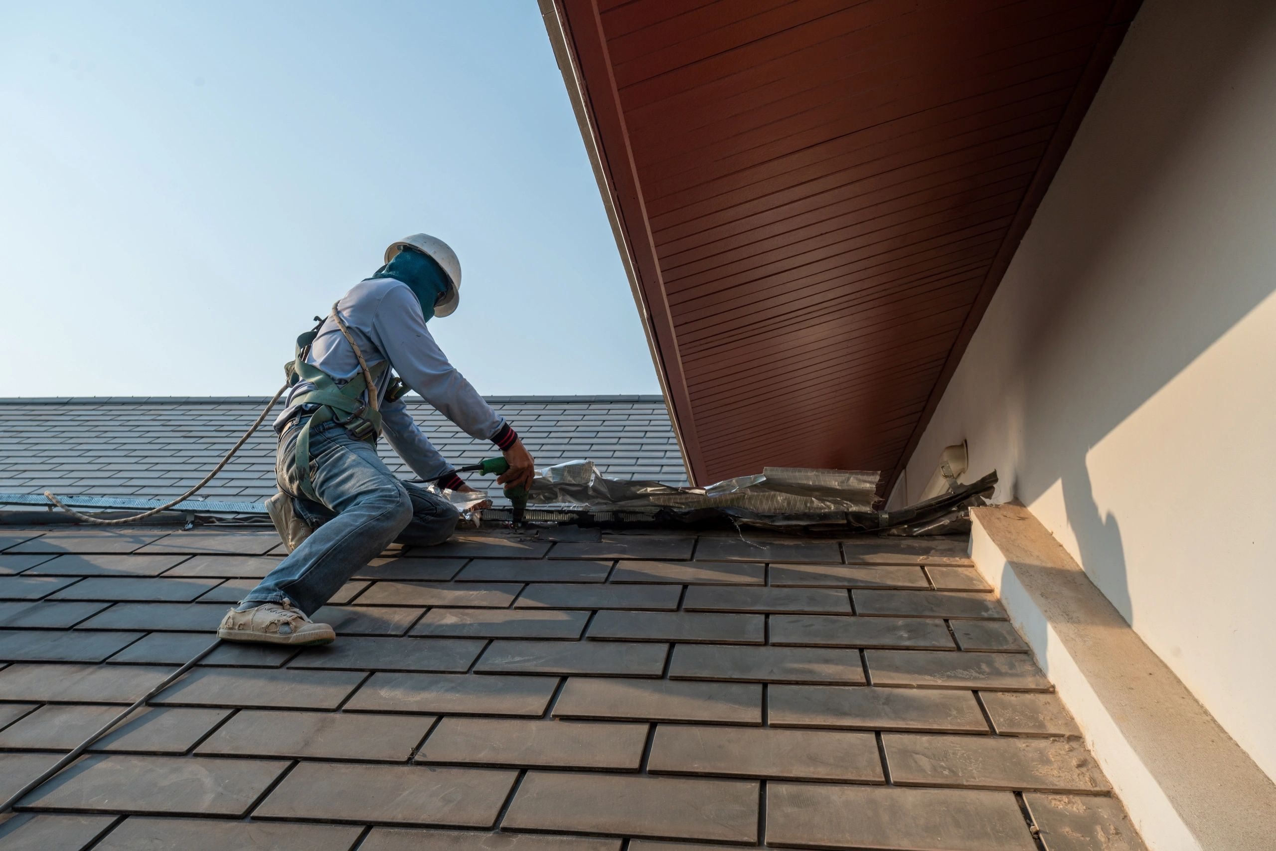 Roofing professional working on residential roof